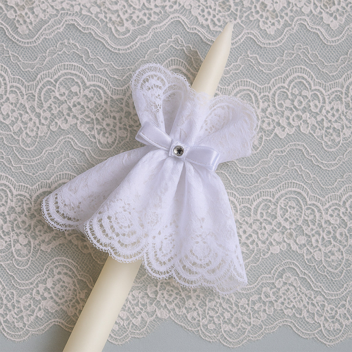 Decorative candle withF abric Candle Wraps Set and pearl accent on a lace background