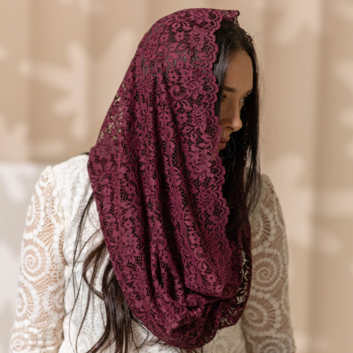 Woman wearing a Catholic Infinity Veil  with a blurred background