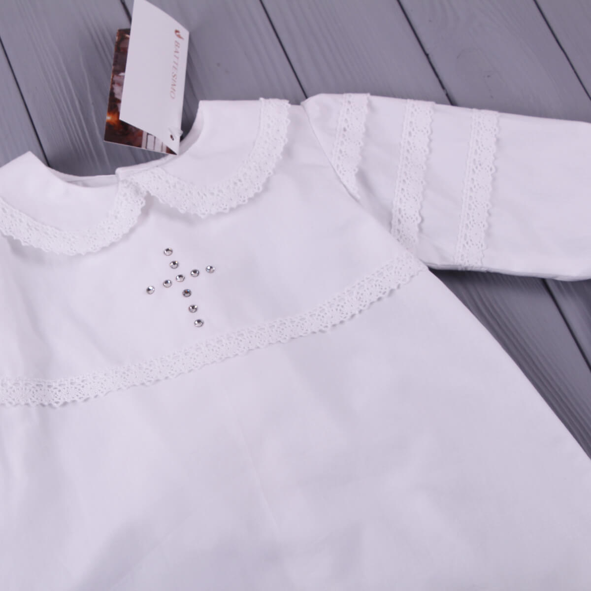Baptism Outfit for Boys with lace details on a wooden surface