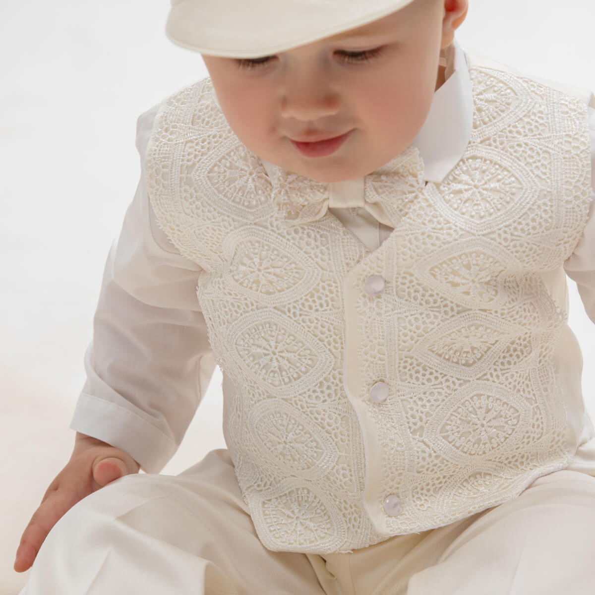  Baby Boy Baptism Suit lace vest over a white shirt and pants on a light background