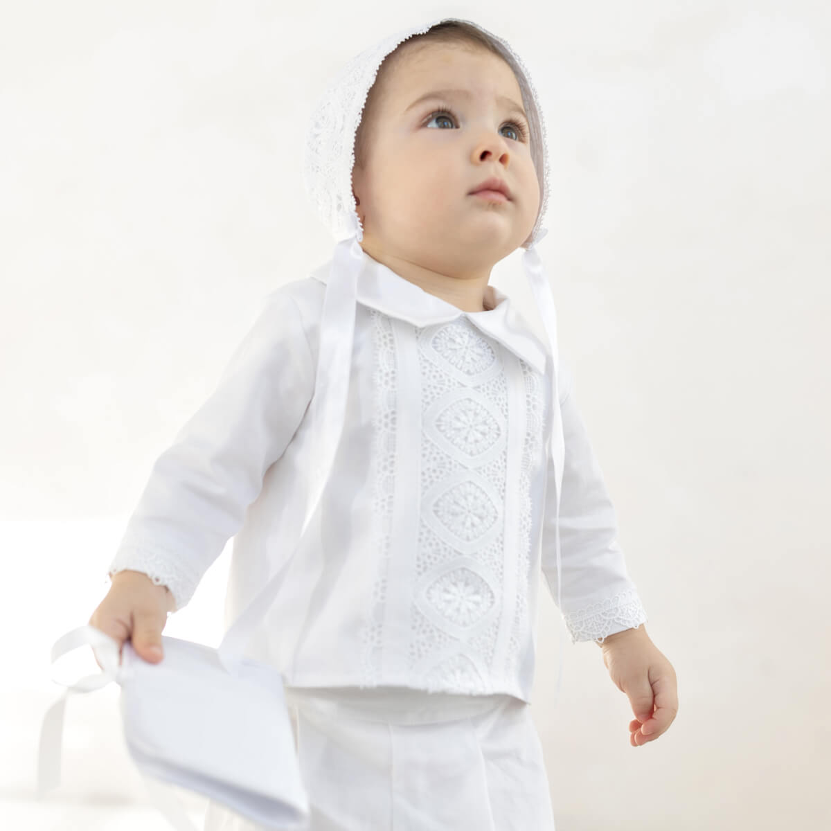 Baby wearing a Baby Boy Christening Suit  with a plain background