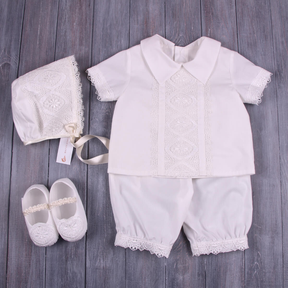 Baptism Outfit for Boys with shirt, shorts, shoes, and bonnet on a wooden surface