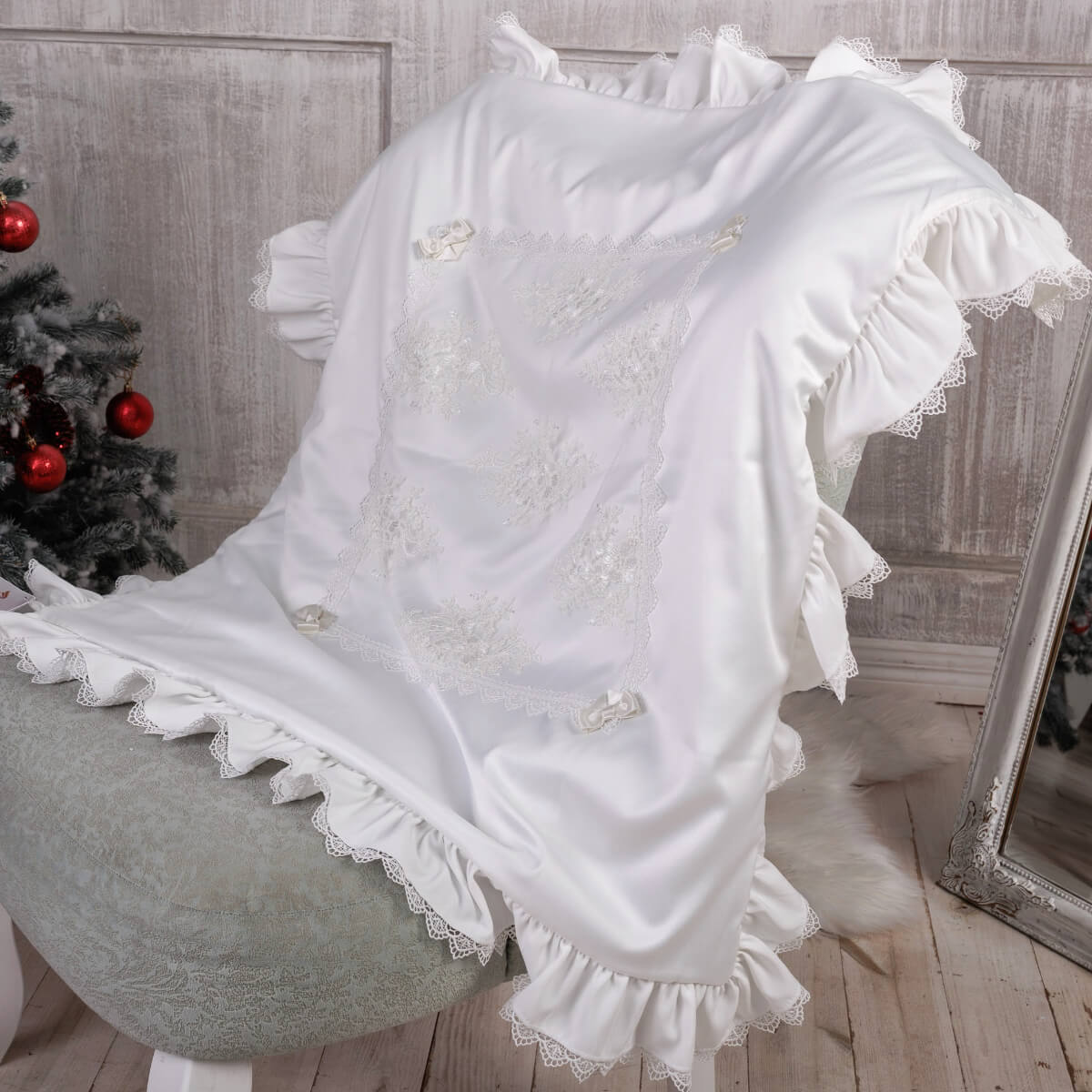 White lace-trimmed blanket draped over a chair