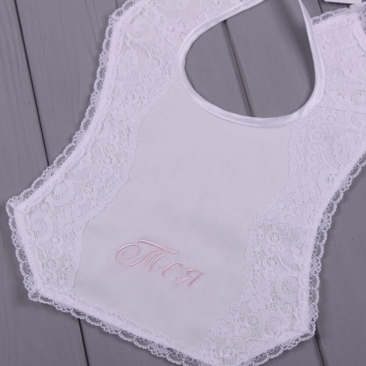 Personalized Baby Keepsake Bib with 'Olivia' embroidery on a gray background