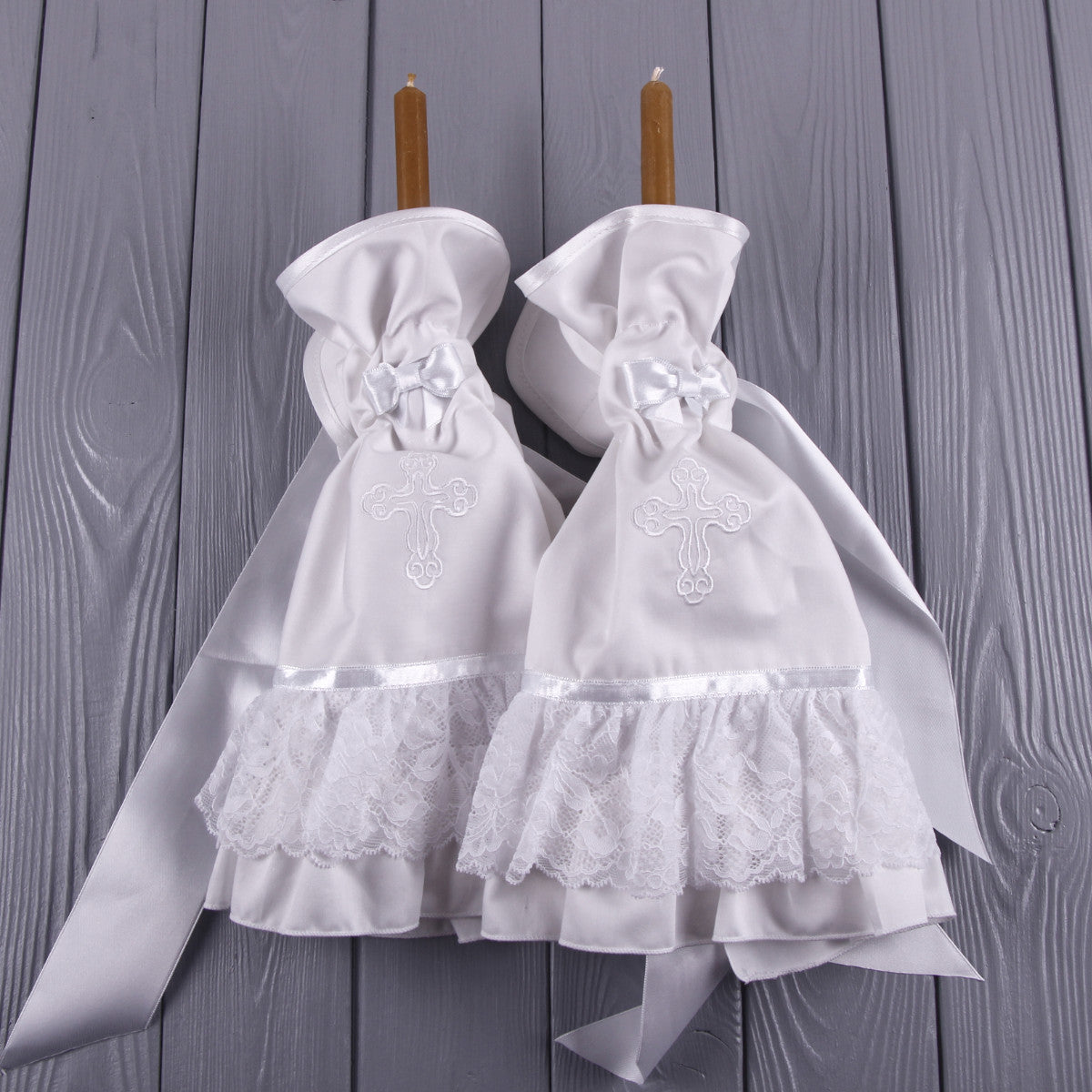 Candle Wraps with embroidered crosses on a wooden background
