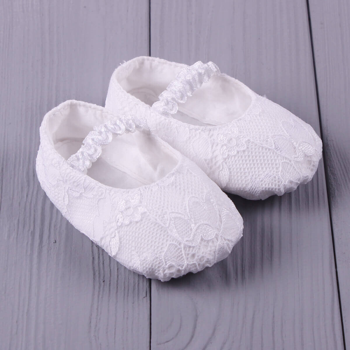  Christening Booties on a gray wooden surface