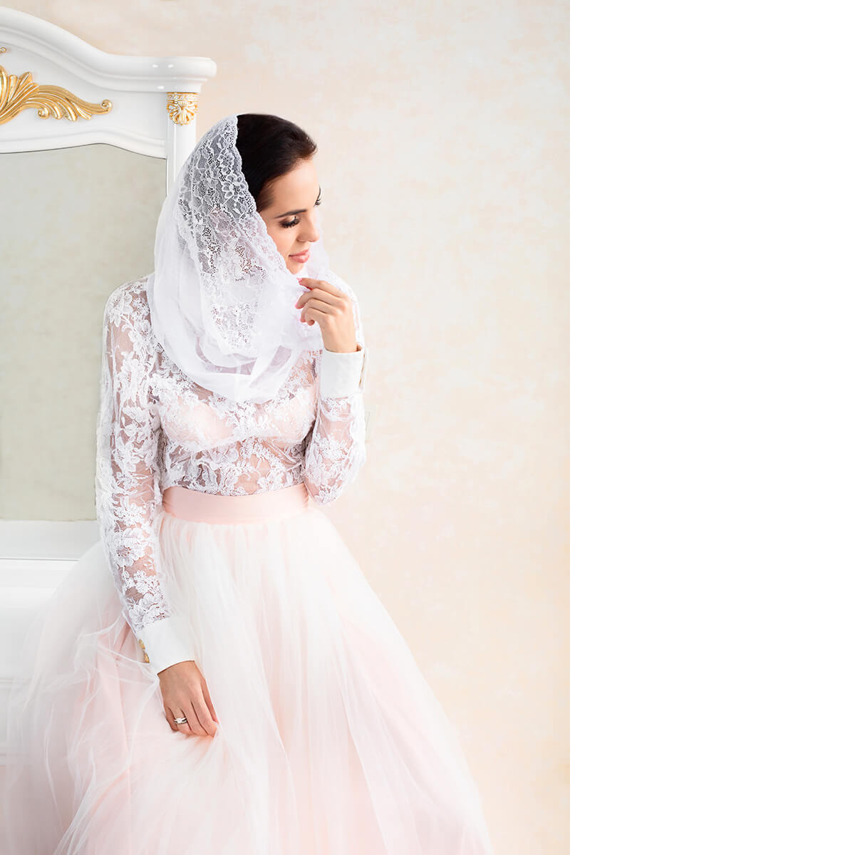 Woman wearing a  Infinity Veil and dress against a light background