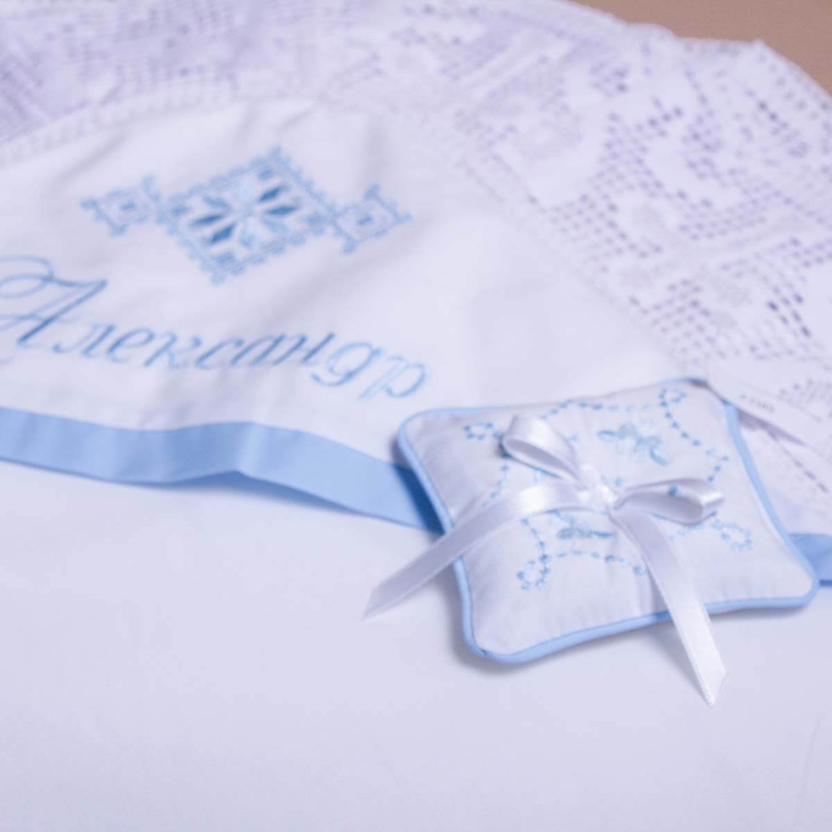Baby blanket with embroidered name and Christening Cross Bearer on a light background