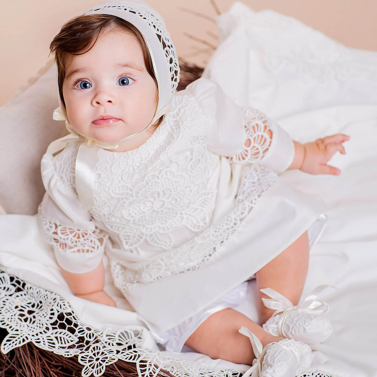 Baby in a  Baptism Gown for Baby Girl with a bonnet on a soft beige background