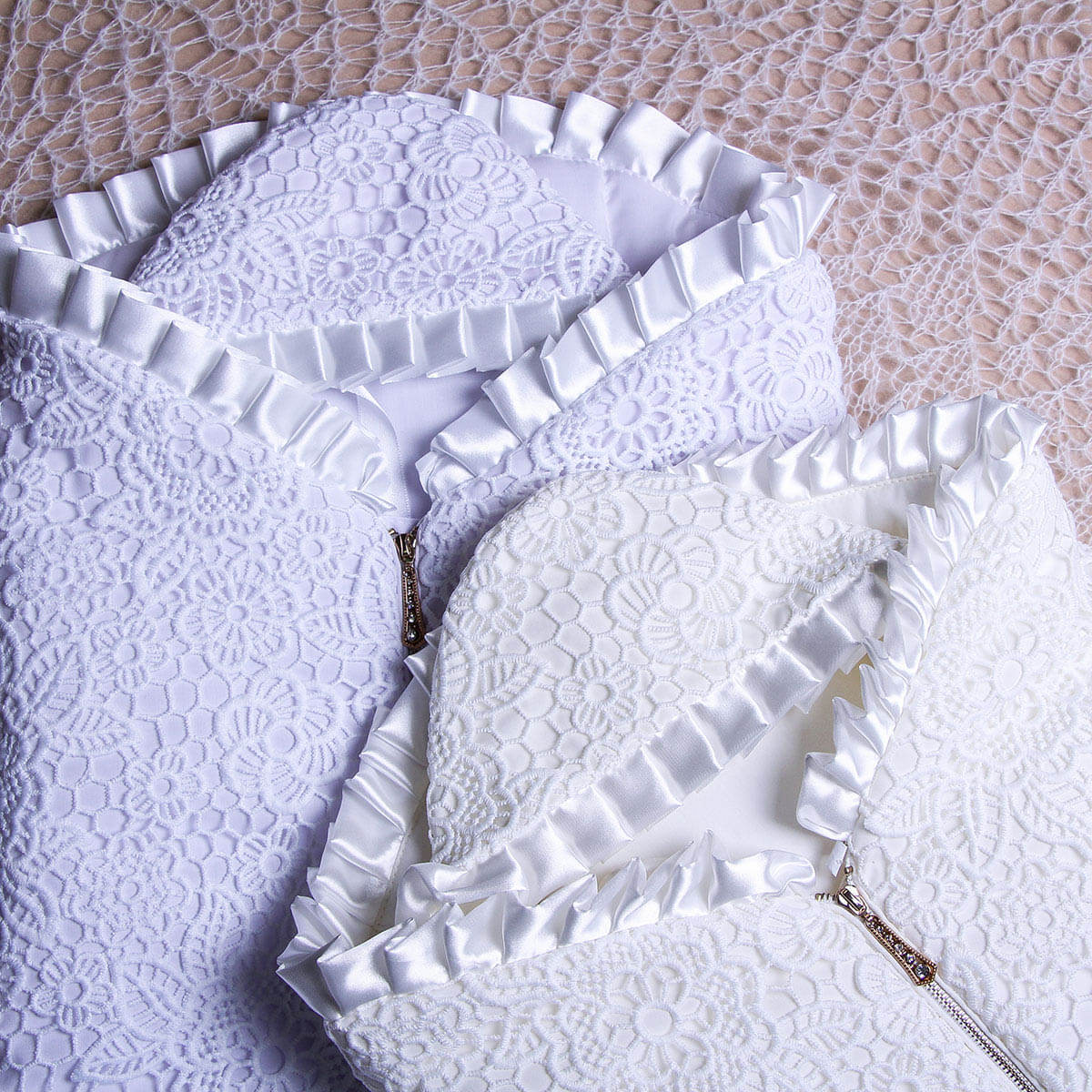 Sleeping sack with hat for summer  on a textured beige surface