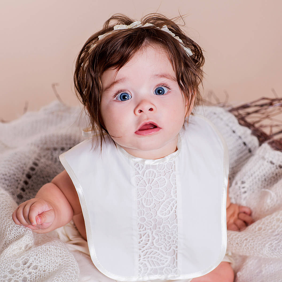 Newborn Lace Bib and headband on a soft, neutral background