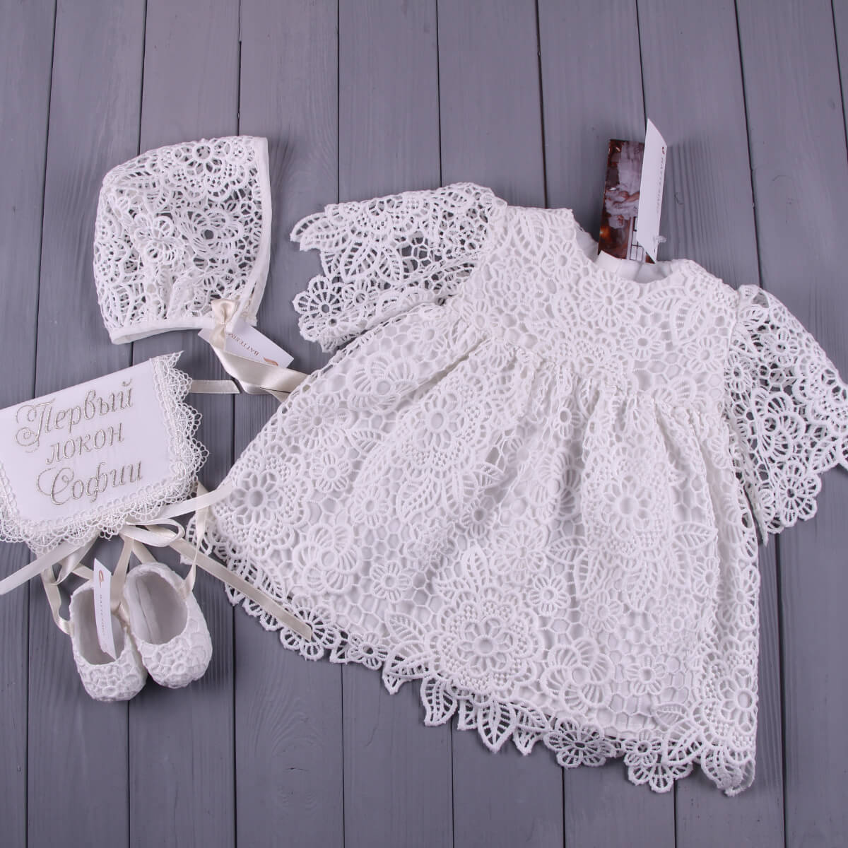 White lace baby dress with bonnet, Christening Booties  on a wooden surface