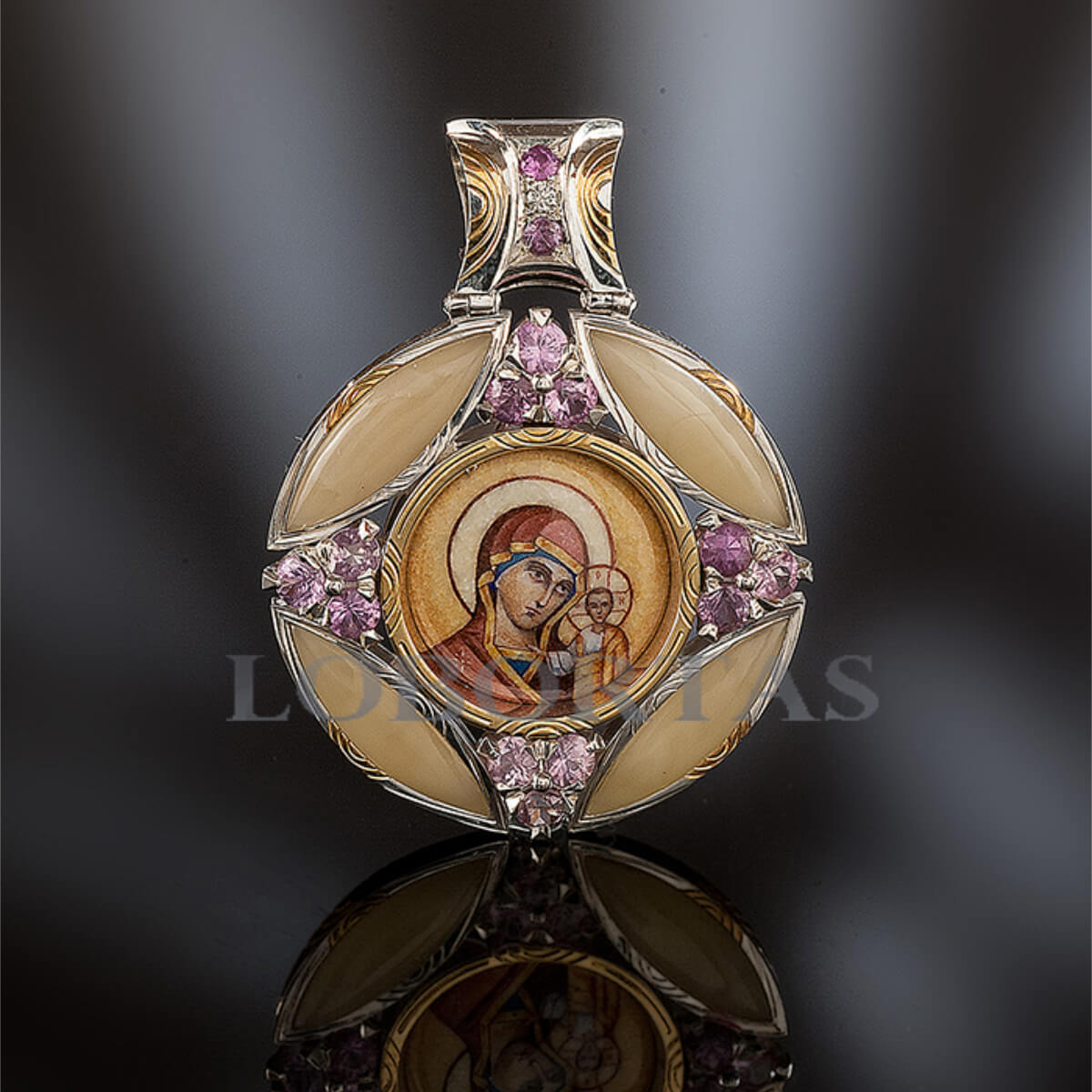 Decorative pendant with religious icon and pink gemstones on a dark background