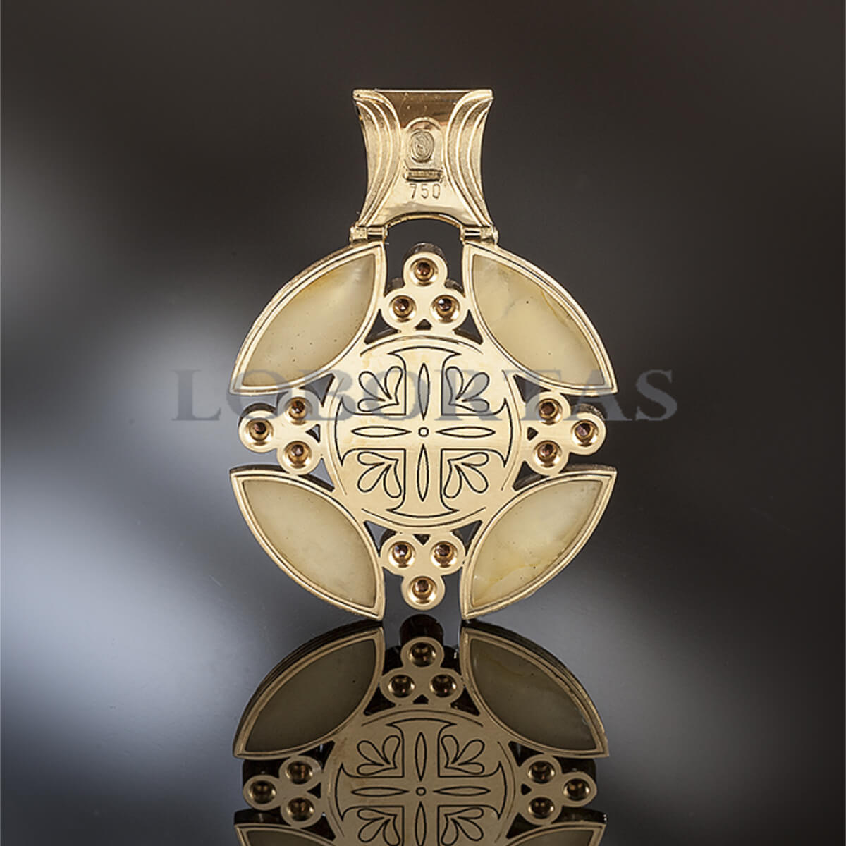 Gold cross pendant with intricate design on a reflective surface