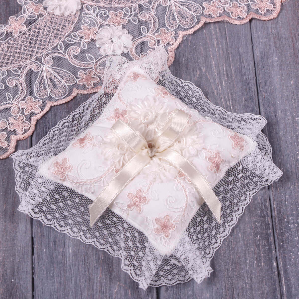 Baptism Ceremony Pillow with lace and bow on a wooden surface
