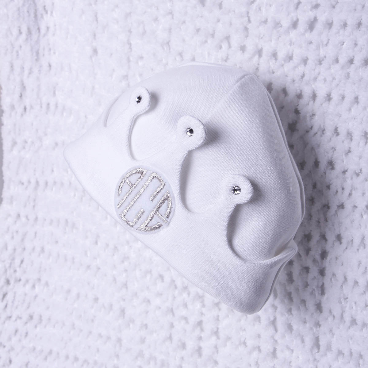 White baby newborn  with heart designs on a textured white background