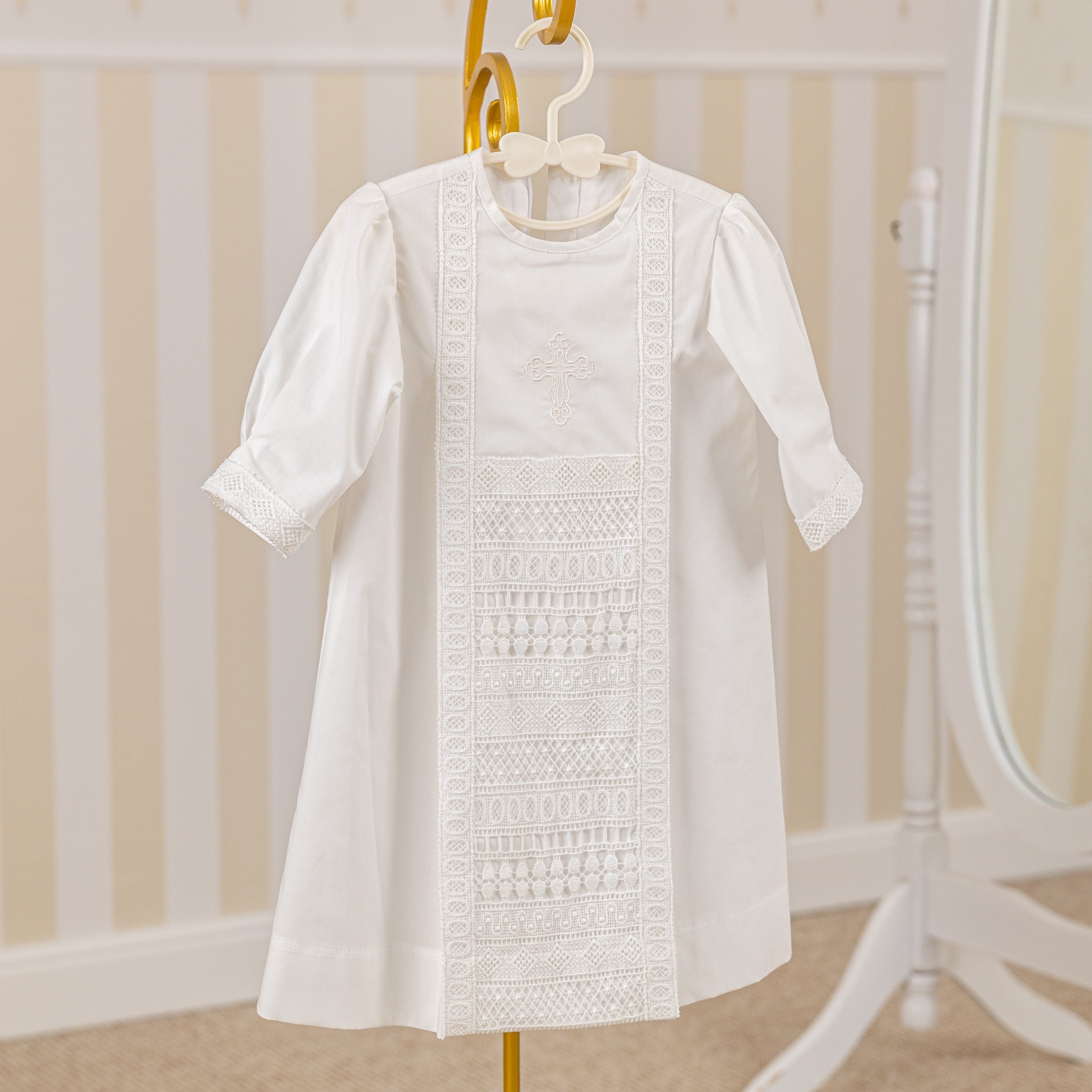 Baptism Gown for Boy with lace details on a hanger against a neutral background