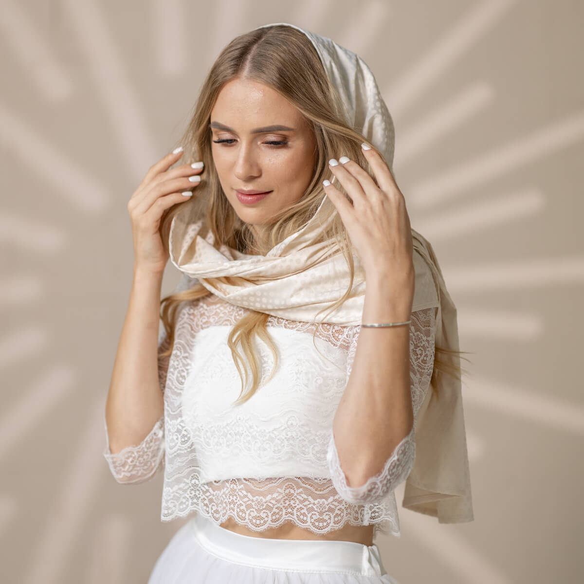 Woman wearing a Silk Chapel Veil against a beige background