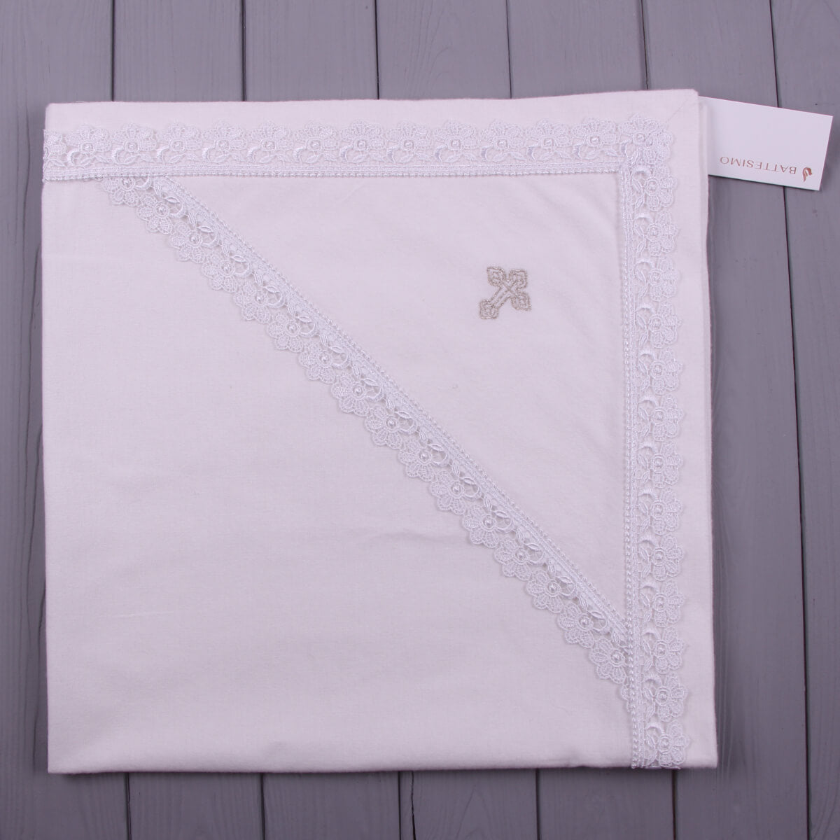 Baby Soft baptism blanket on a wooden surface with a visible brand tag.