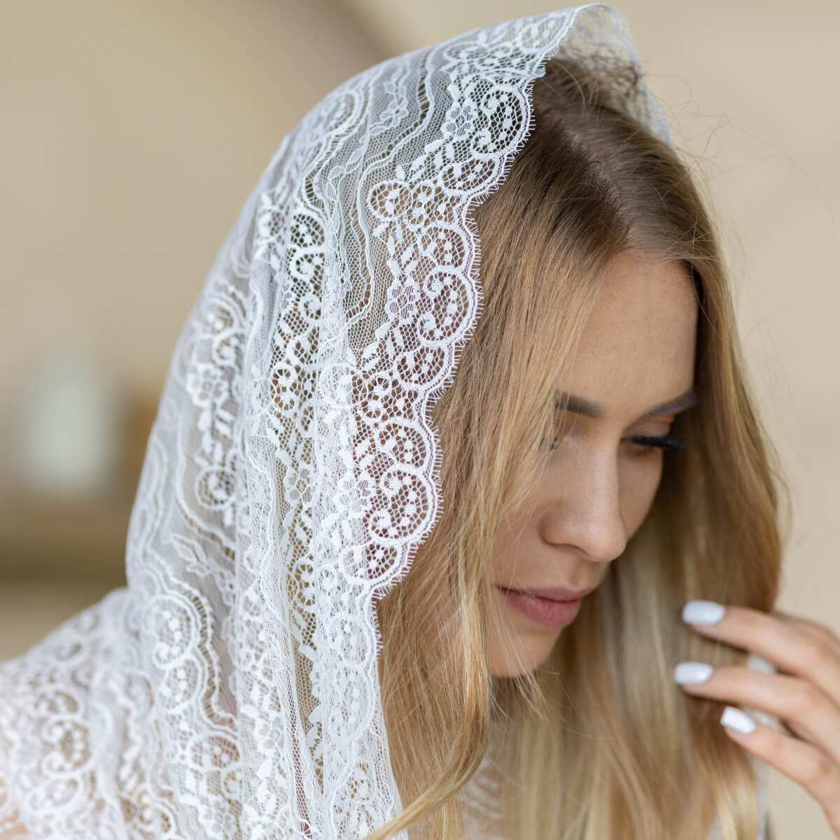 Woman wearing a Catholic Infinity Veil  with a blurred background