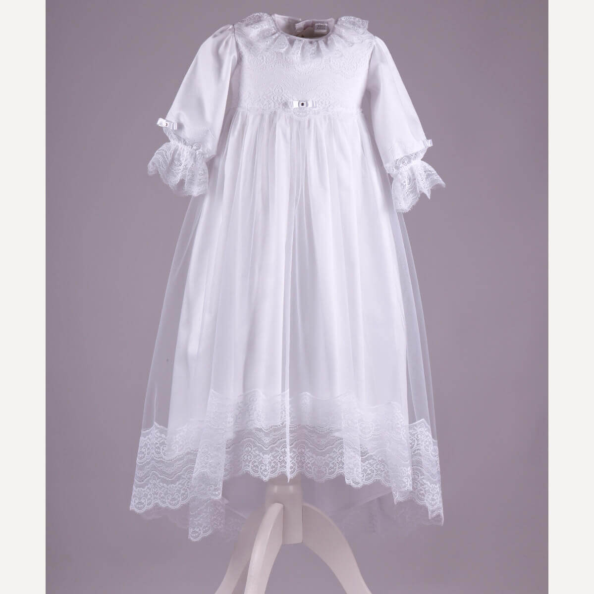 Christening Gown for Girls on a mannequin against a purple background