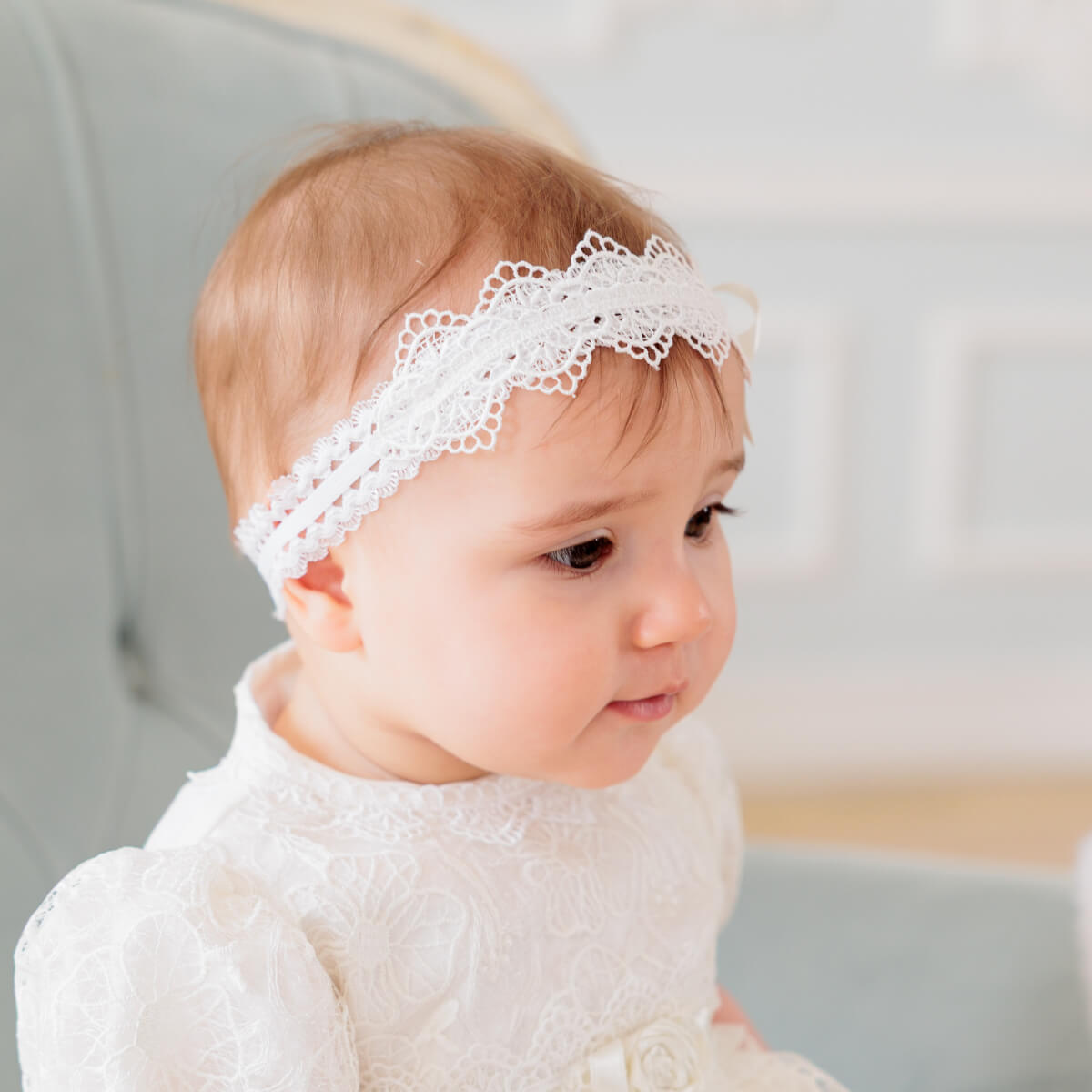 Girl wearing baby headband with a blurred background