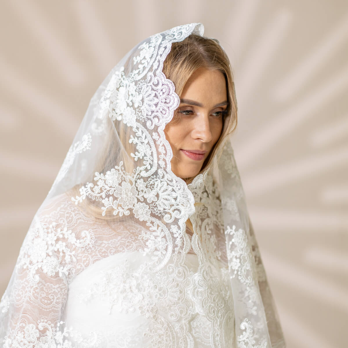 Woman wearing a  Church Mantilla against a beige background