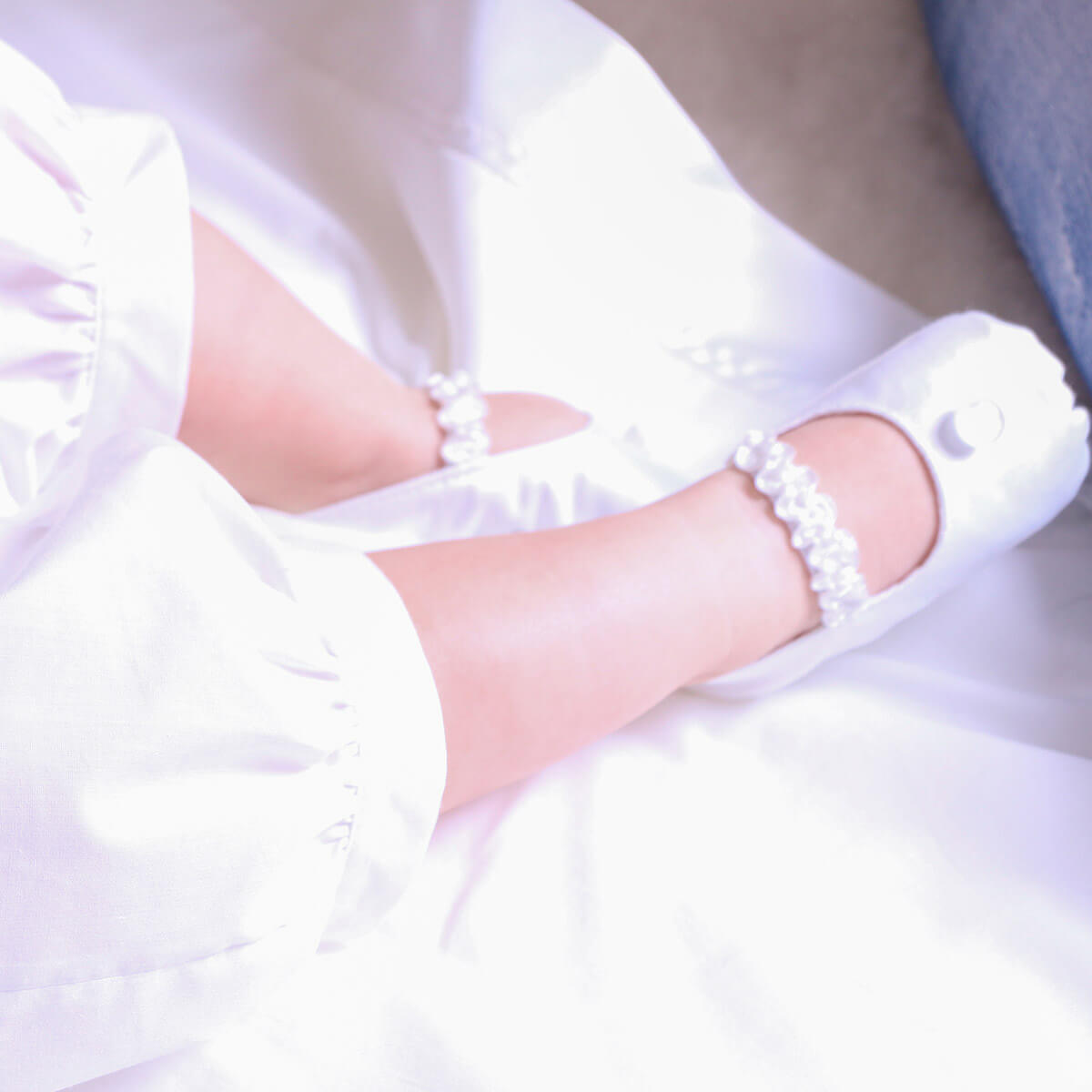  Christening Booties with pearl details worn by a bride in a white dress.
