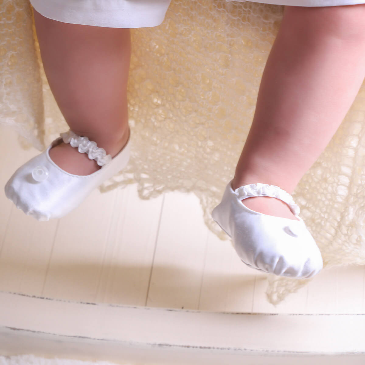  Christening Booties with decorative elements on a light background