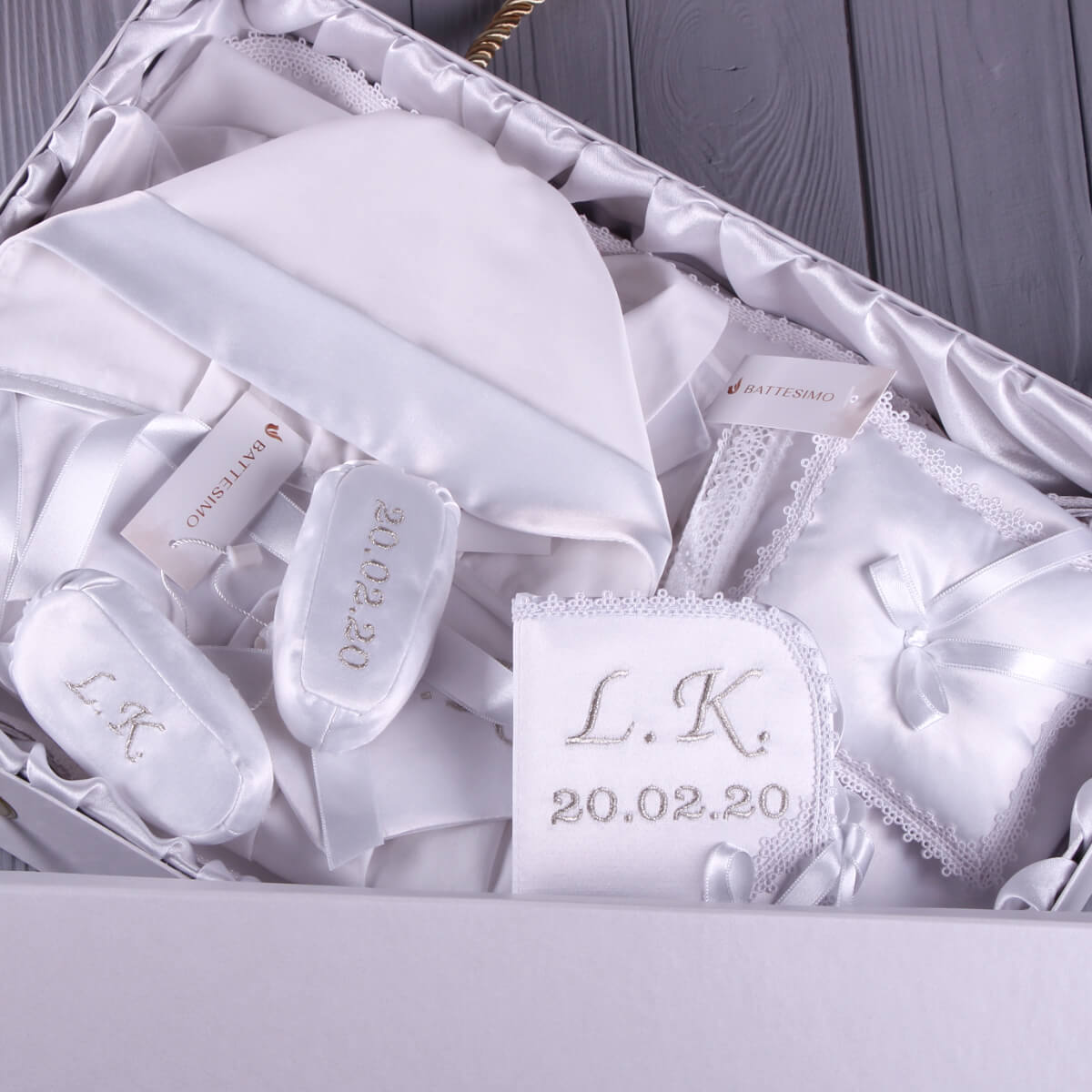 Boy Christening Hat with 'L.K.' and a date on packaging