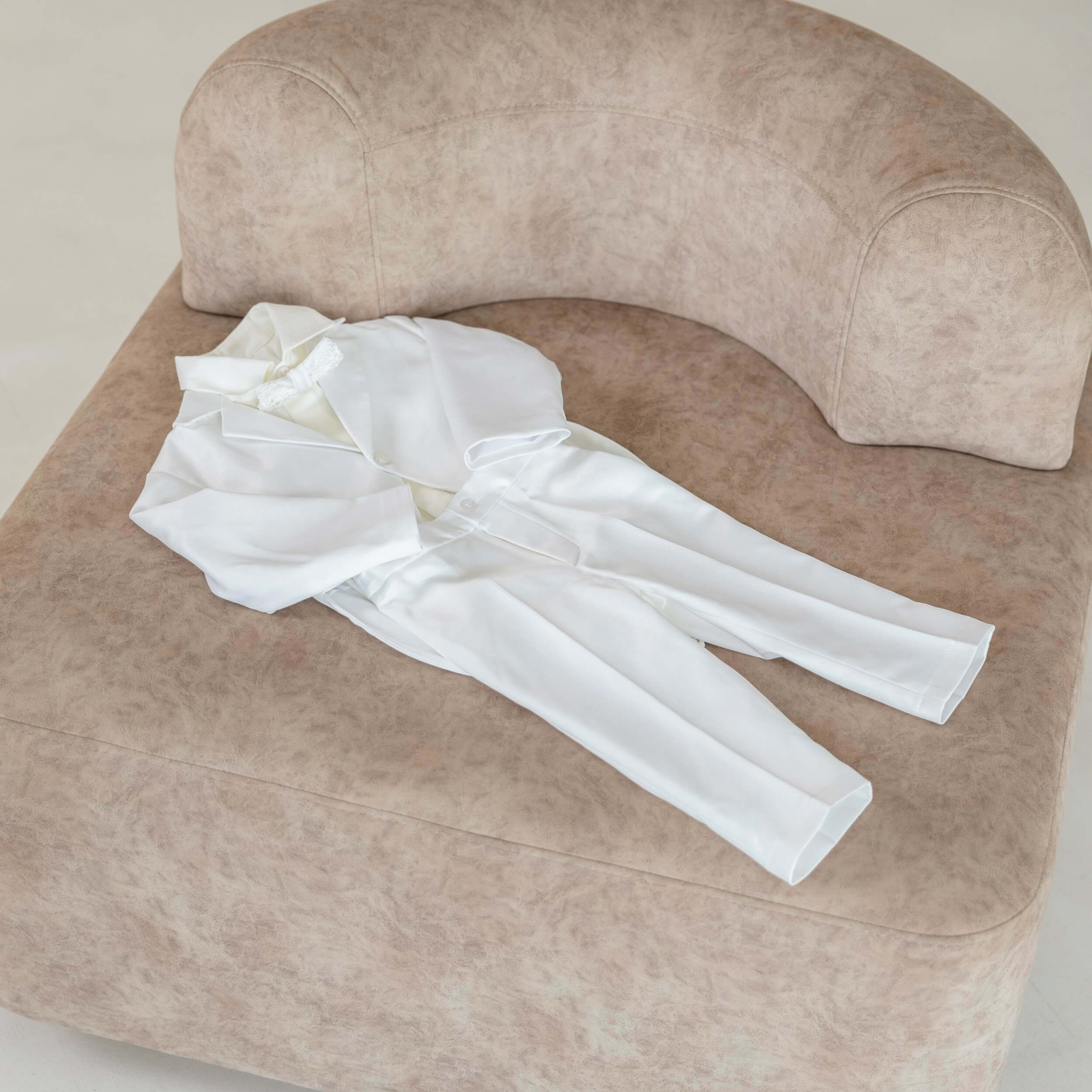Baptism Suit for Baby Boys on a beige armchair