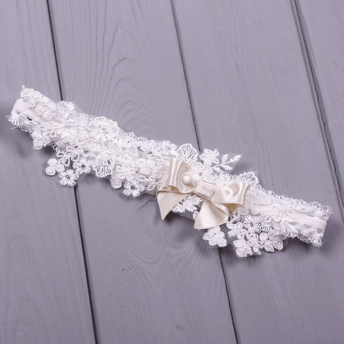 Baby headband with a bow on a wooden surface