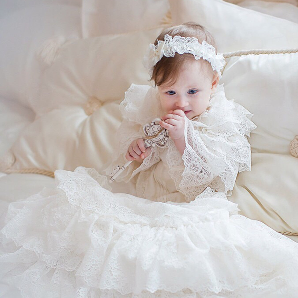 Baby in a white lace christening gown 