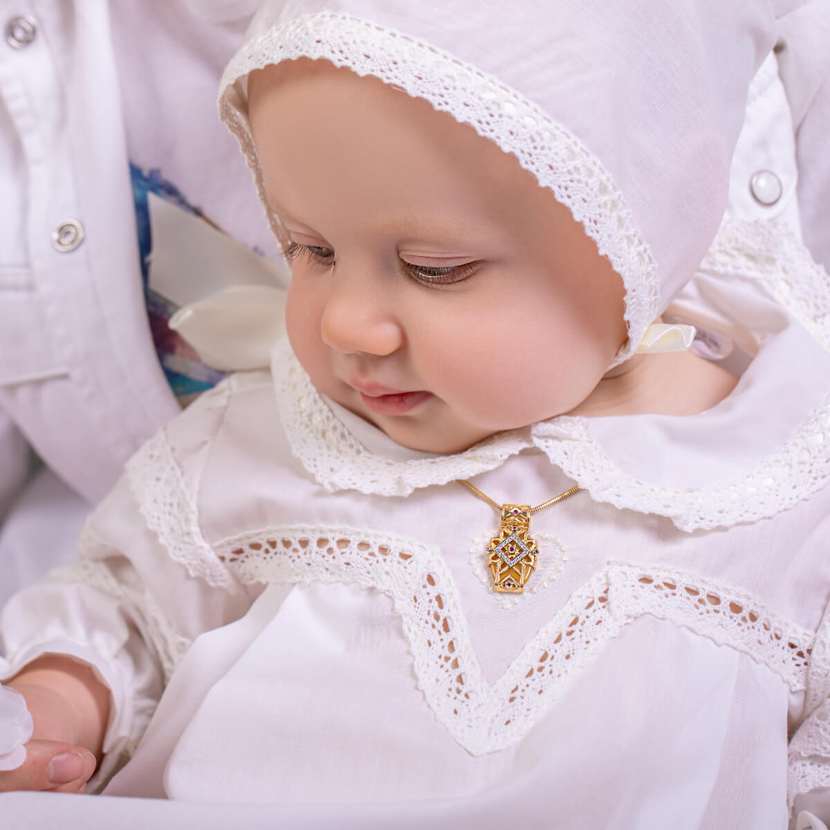 Baby wearing a Girls Baptism Gown with lace details and a gold necklace.