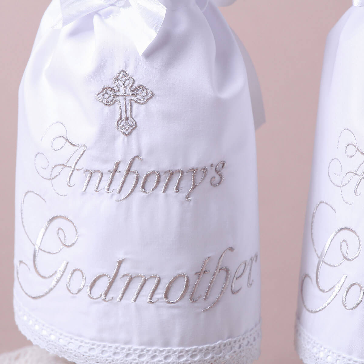 Christening Candle Wraps  with embroidered text and a cross on a beige background
