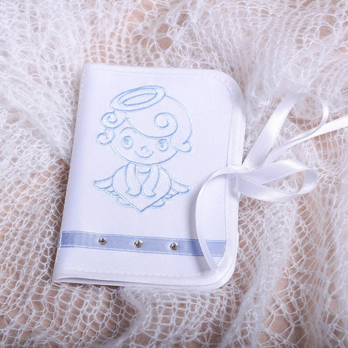 White embroidered angel First Curl Keepsake Box with blue accents on a lace background