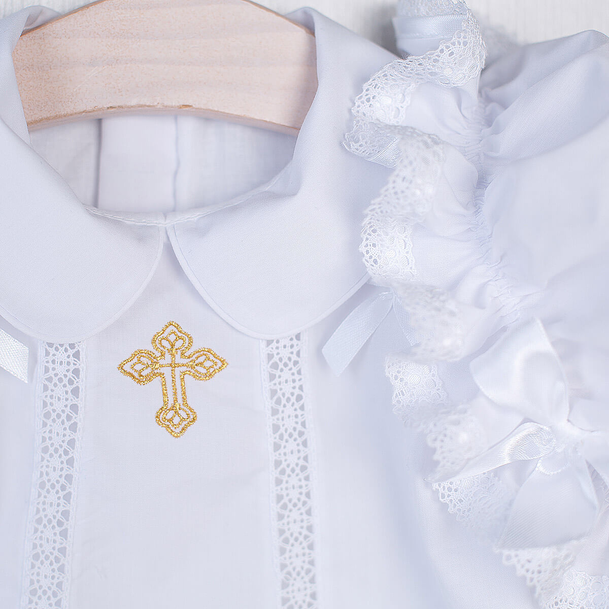 White Christening Dress with gold cross embroidery on a hanger