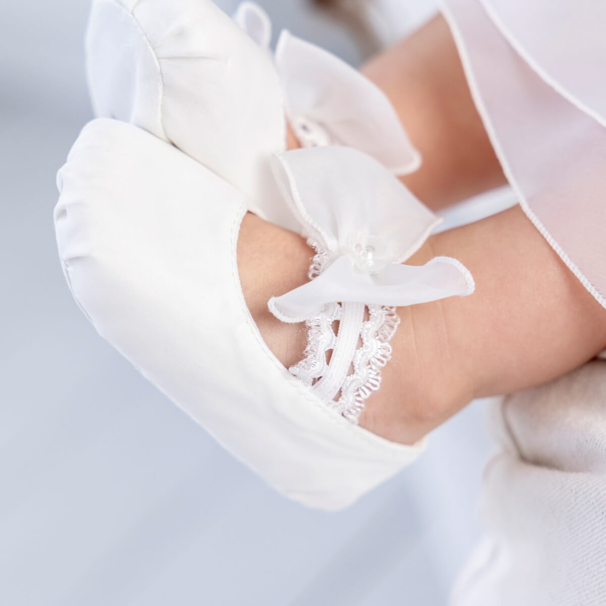 Close-up of Christening Booties on a light gray background