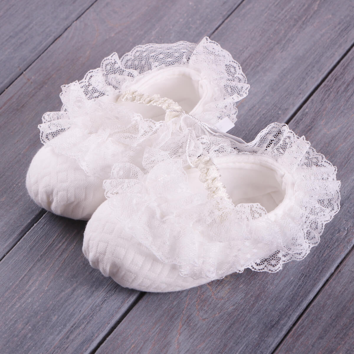 Baptism Romper Set with lace details on a wooden surface