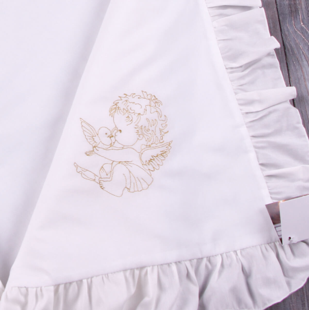 White baptism blanket with gold angel embroidery on a white background