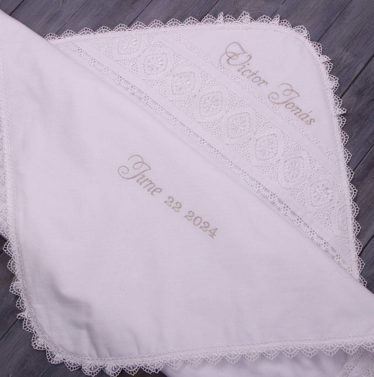 Personalized Baby Keepsake Blanket with lace trim on a wooden surface
