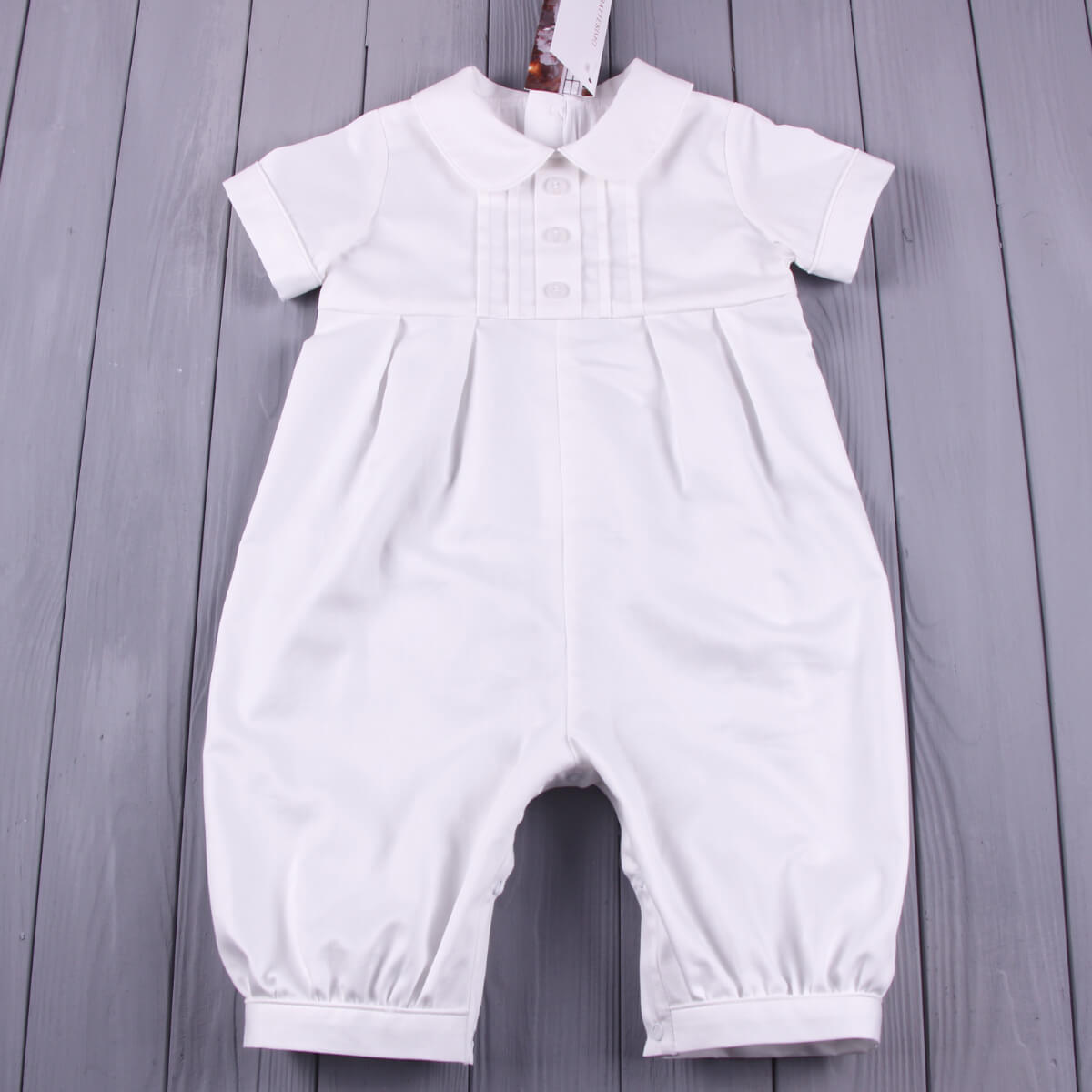 Baby Boy Baptism Bubble Romper on a wooden surface