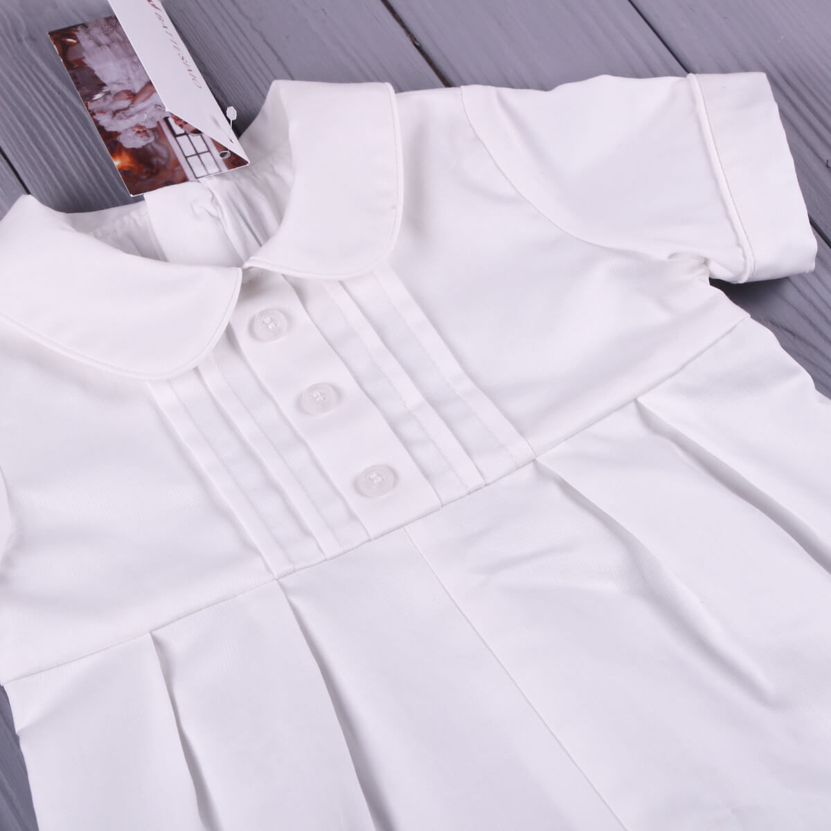 Baby Boy Baptism Bubble Romper on a wooden surface