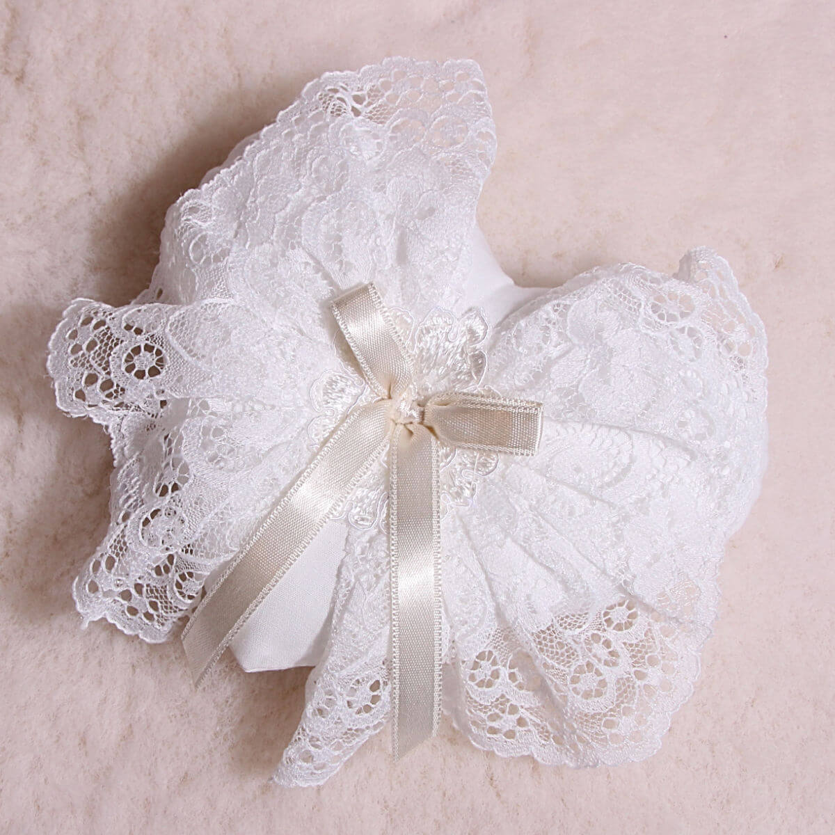 Baptism Ceremony Pillow with a ribbon on a beige background