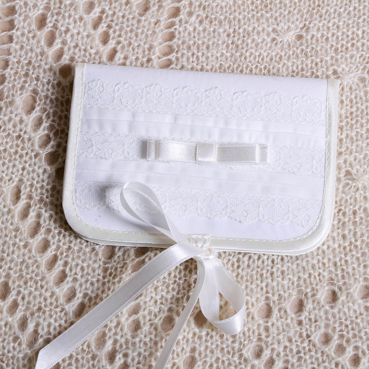 First Curl Keepsake Box for Baptism with a bow on a textured beige surface