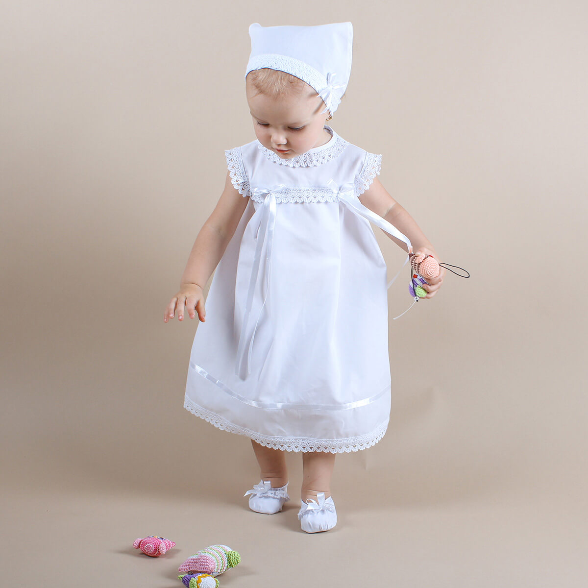 Summer Baptism Dress Set for Girl and bonnet standing on a beige background