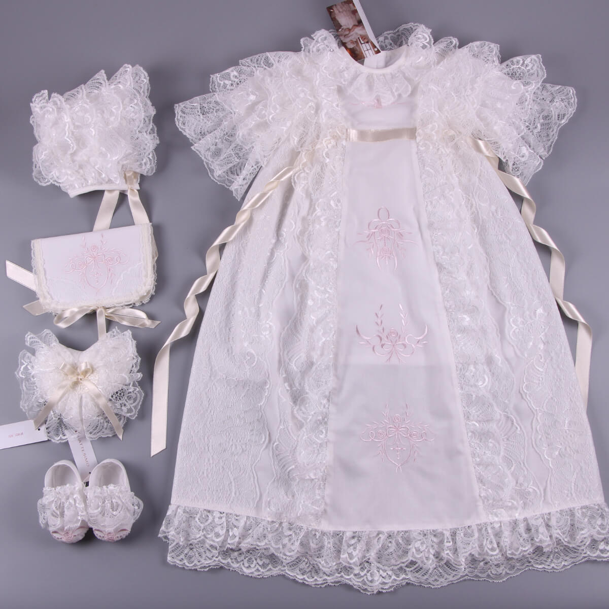 White lace baby dress with  lace baptism bonnet on a gray background