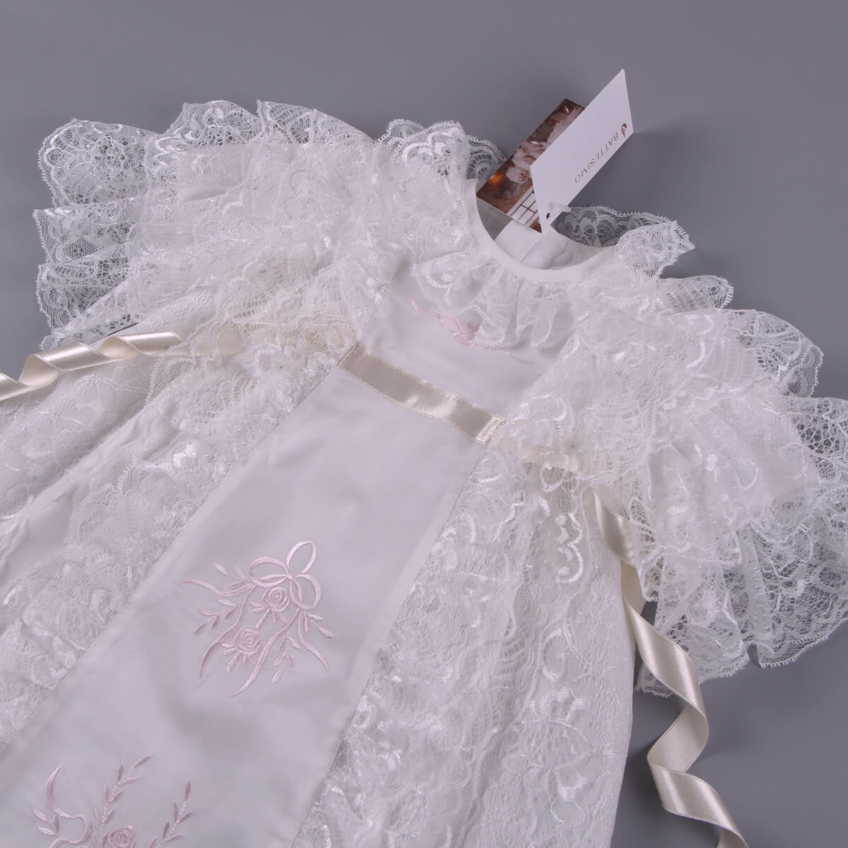 Christening Gown for Girls with embroidery on a gray background
