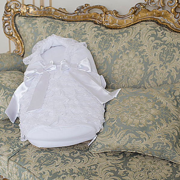 Newborn Sleep Sack on a decorative sofa with gold accents