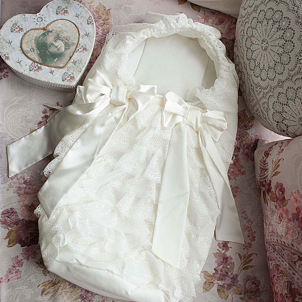 Baby Sleep Sack with a bow on a floral fabric background